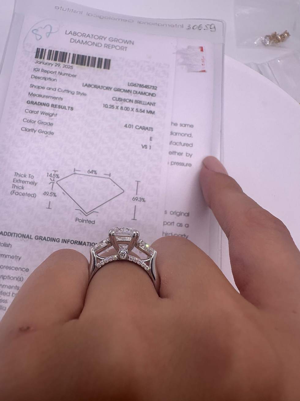 Thumbnail: 4.01 carat E VS1 elongated cushion diamond with trillion side stones 