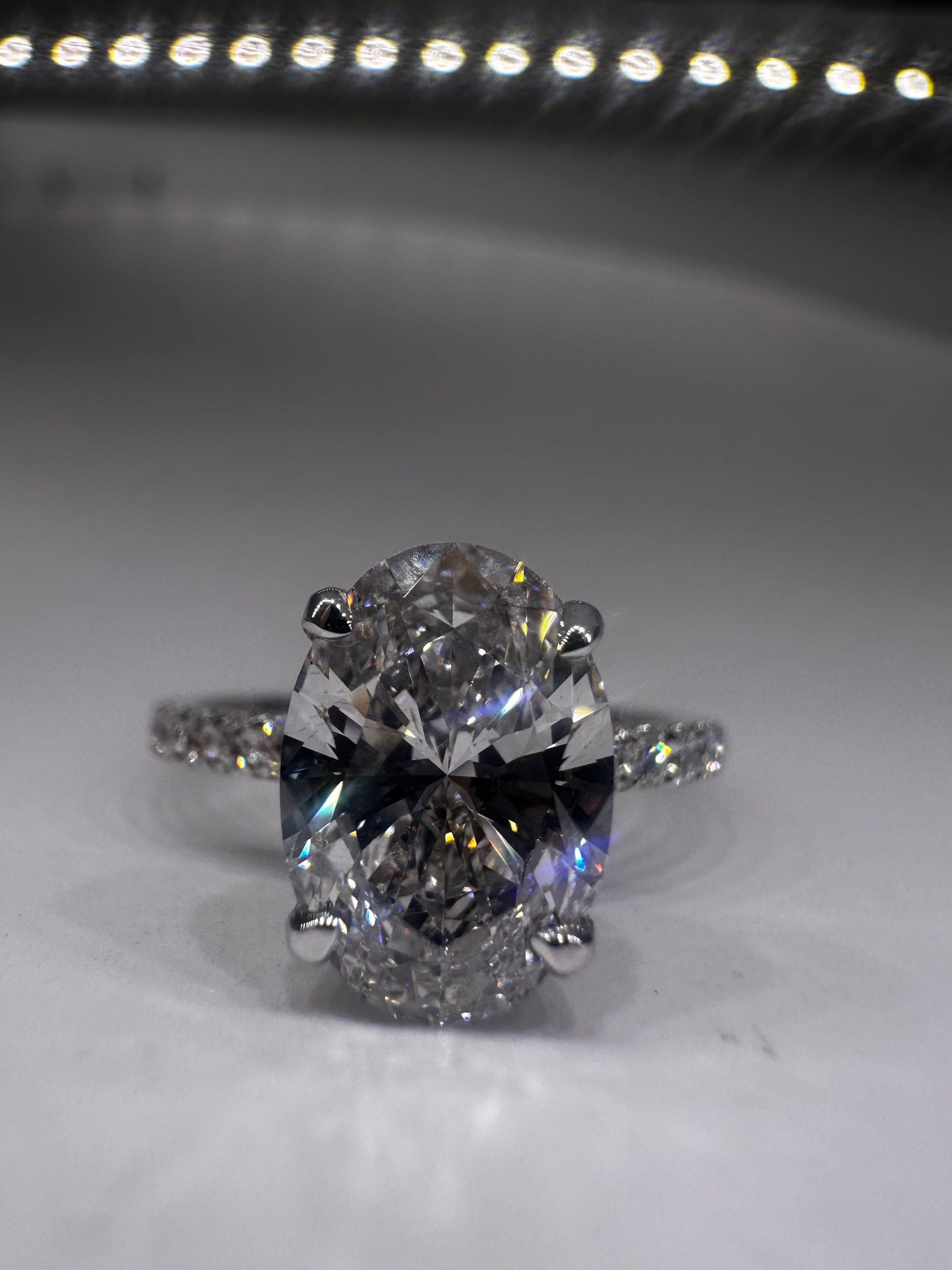 2.04 carat E VS1 oval lab diamond on a pave band with hidden halo white gold
