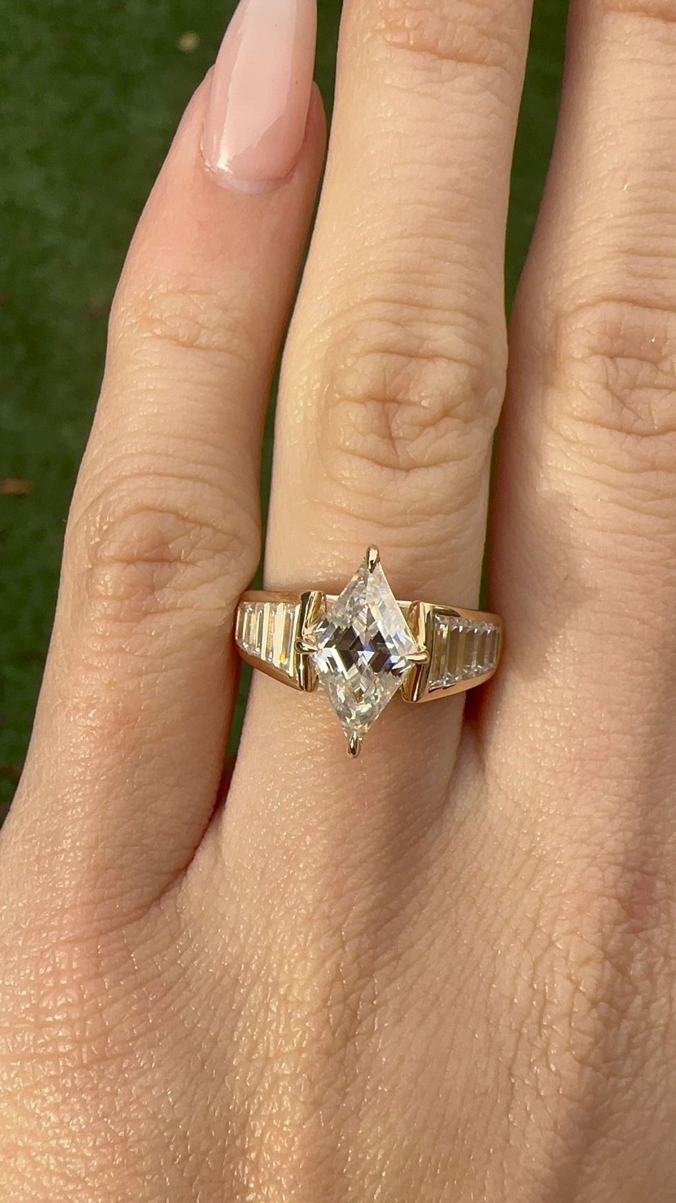 Thumbnail: 2 carat rhombus moissanite in a wide channel set baguette band 