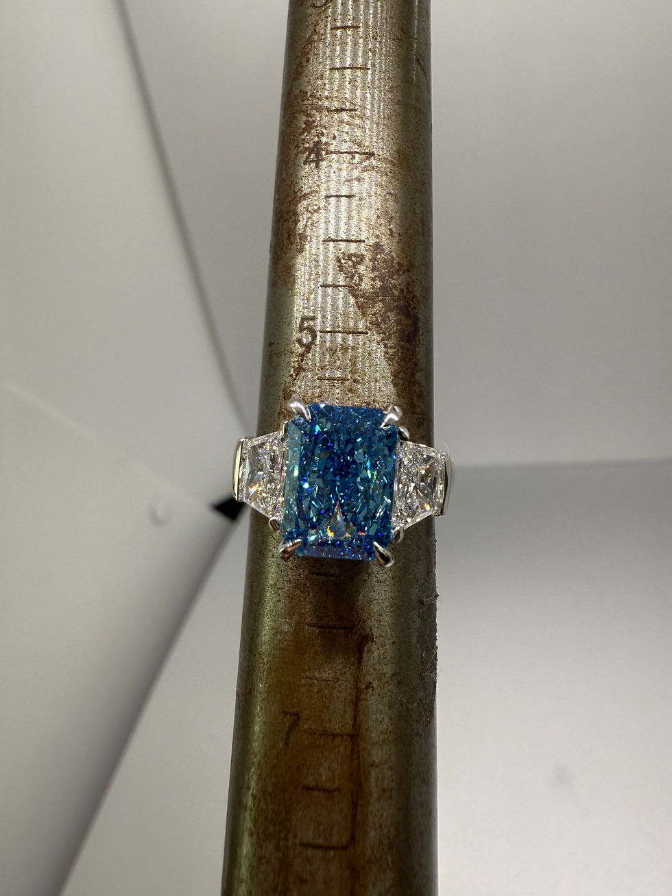 Thumbnail: 4.09 carat fancy vivid blue radiant lab diamond with trapezoid side stones 