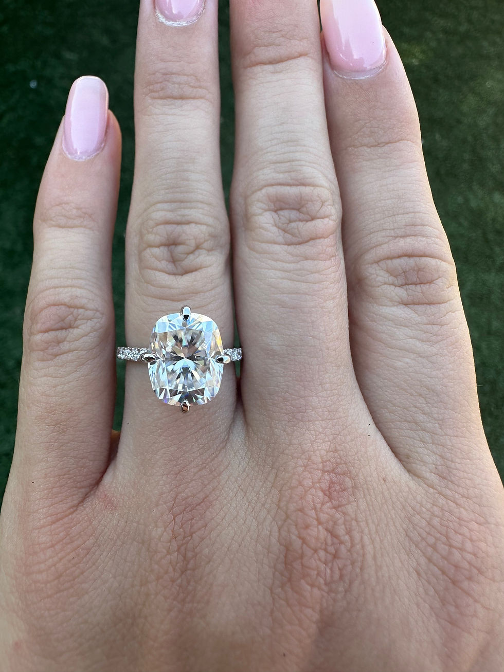 Thumbnail: 4.5 carat cushion moissanite with compass prongs on a pavé band 