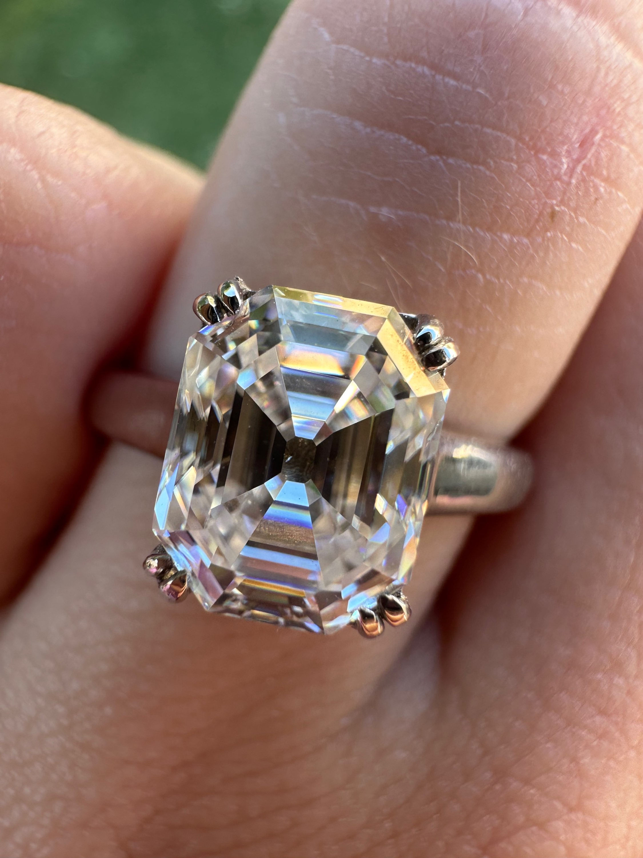 3 carat antique emerald cut moissanite with double prongs on 14k white gold