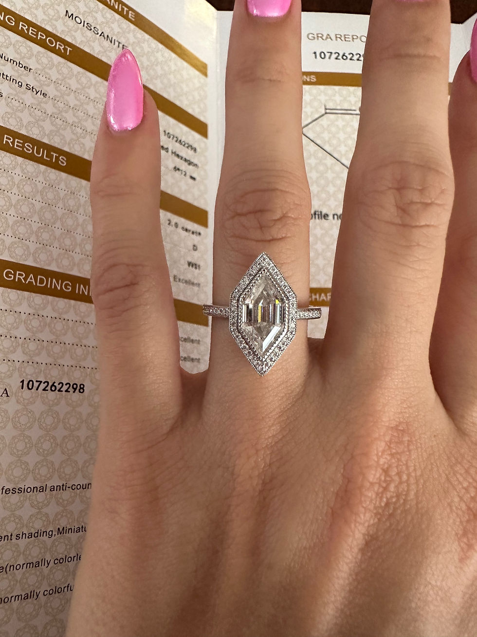 Thumbnail: 2 carat elongated hexagon with milgrain detaling and halo with pave band 