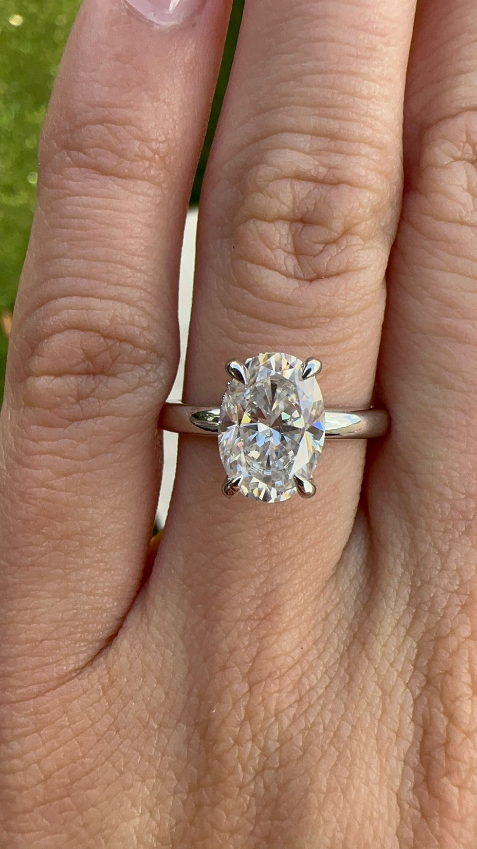 Thumbnail: 7x10mm elongated oval cut moissanite ring with hidden halo