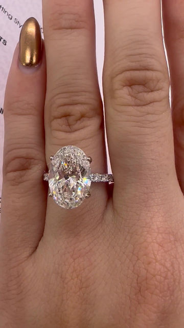 Thumbnail: 5.05 carat G VS2 oval diamond ring with a pavé band 