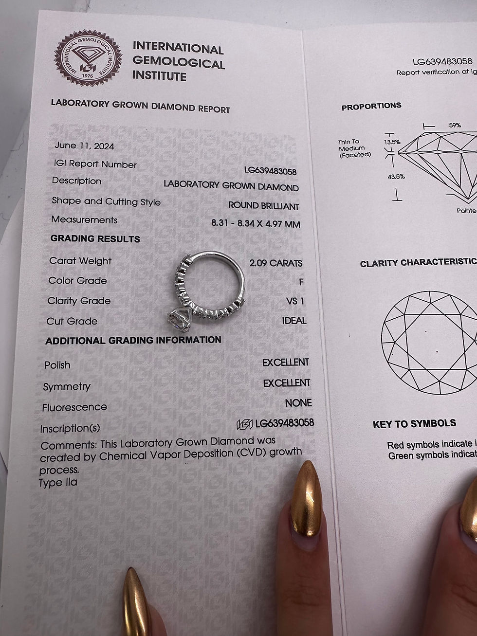 Thumbnail: 2.09 carat F VS1 round lab diamond on a bubble band 