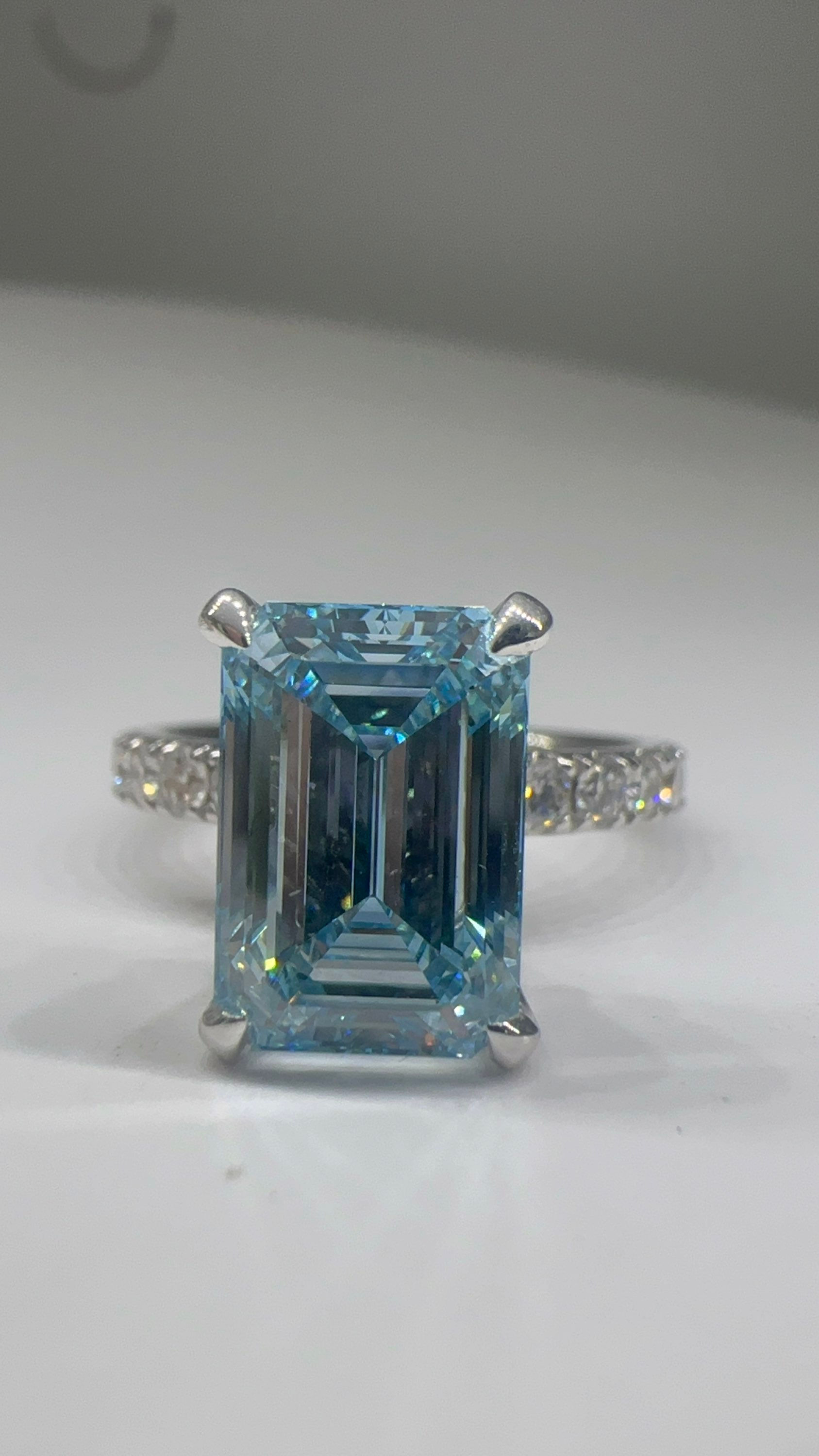 4.04 carat fancy intense blue VS2 emerald cut lab diamond on a pavé band 