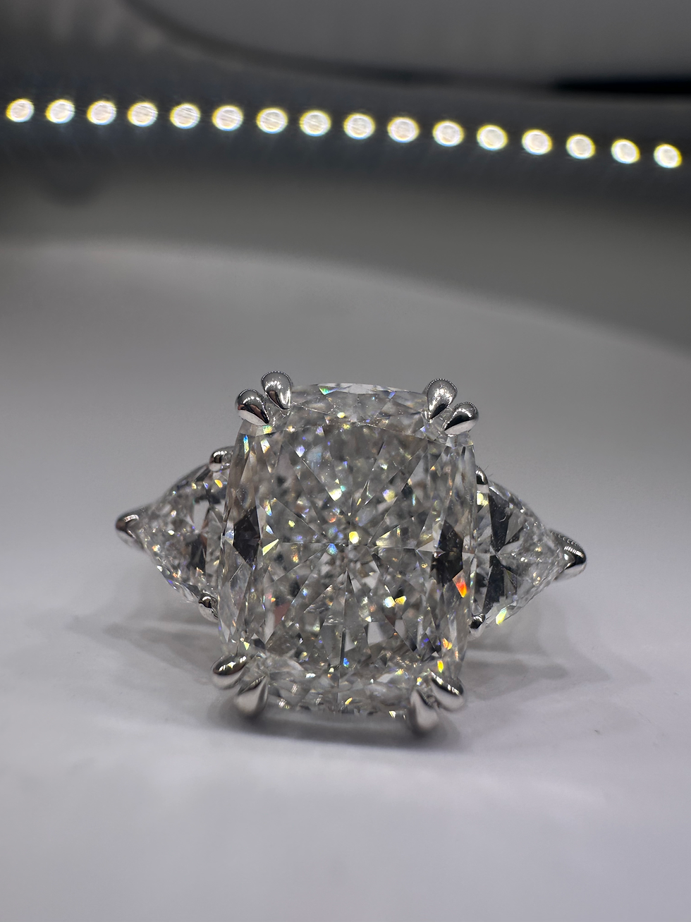 Thumbnail: 4.01 carat E VS1 elongated cushion diamond with trillion side stones 