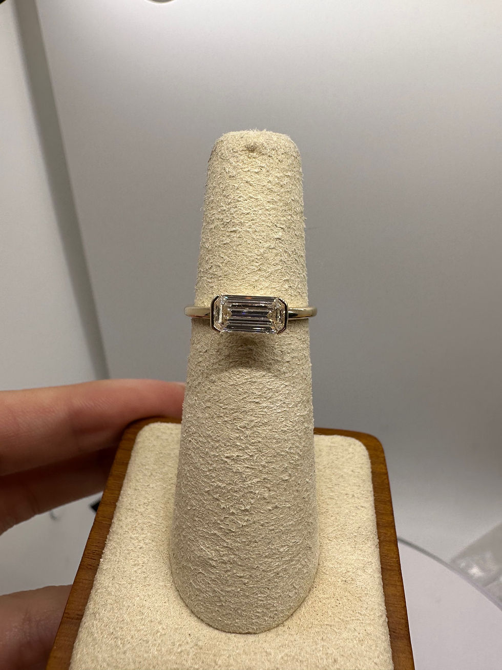 Thumbnail: 0.91 carat E SI2 east west emerald cut natural diamond half bezel solitaire 