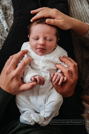 Newborn baby and parents hands