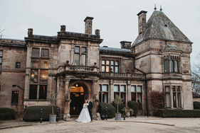 rookery hall exterior with bride and groom posing