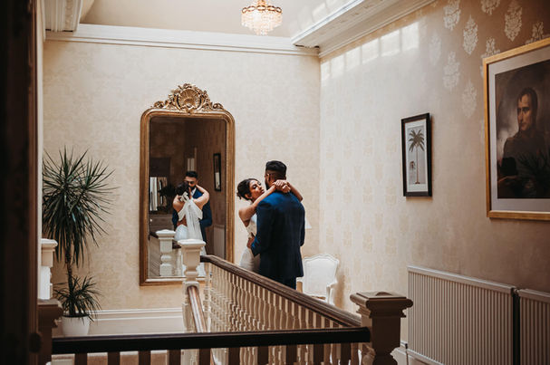 Bride and groom by staircase