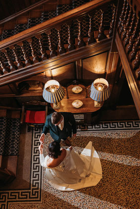 bride and groom dancing below staircase at rookery hall