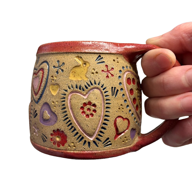 Hand holding Heart Folk Mug 4 with bunny and heart art