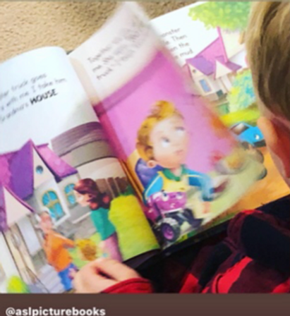 A young child in a red plaid shirt reads My Monster Truck Goes Everywhere with Me, viewing colorful illustrations of a family outside a purple-roofed house. The pages show how to sign the words HOUSE and LOOK, helping children connect illustrations with ASL signs.