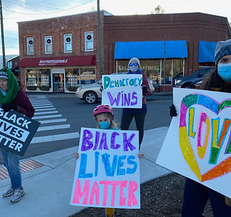 Maggie with her daughter and mother at a protest.