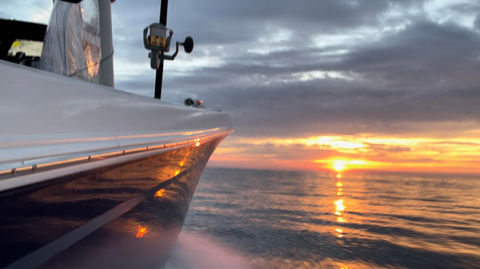 Fishing boat cruising at sunset on Boston’s North Shore.