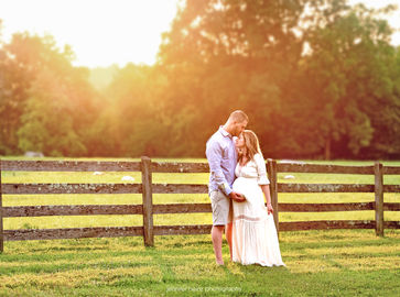 couple before their baby is born at sunset