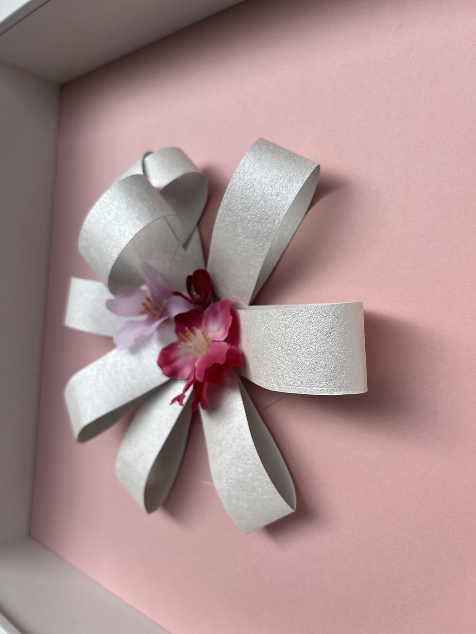 Floral wall art by Nekane Munoz featuring a sculpted wallpaper flower on blush pink for soft, modern interiors.