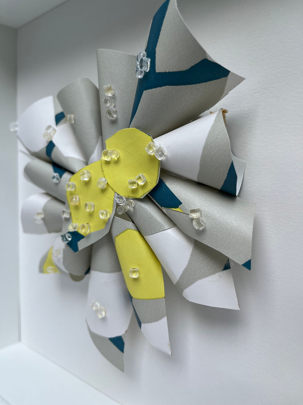 Handcrafted wall art featuring folded premium wallpaper, inspired by abstract cut-outs.
