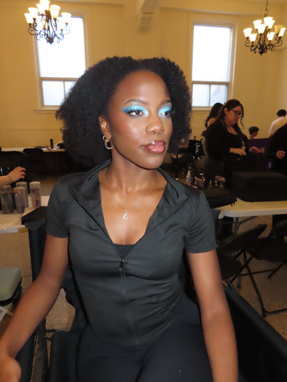 Finished editorial runway makeup on dark skin model featuring glowing skin and vibrant blue eye makeup created with Danessa Myricks Colorfix and Lightwork VII palette