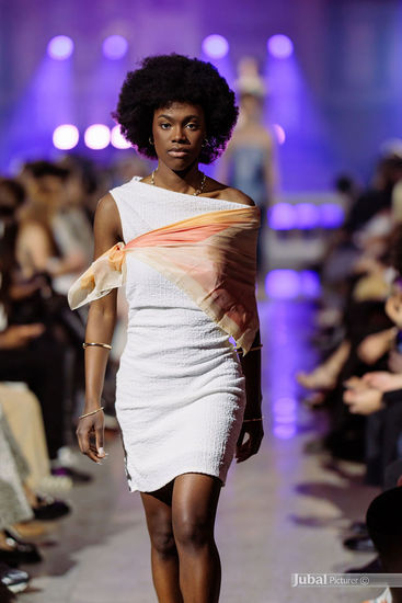 Runway beauty look on dark skin model featuring glowing skin and editorial fashion styling during the GAÏA 2026 runway show
