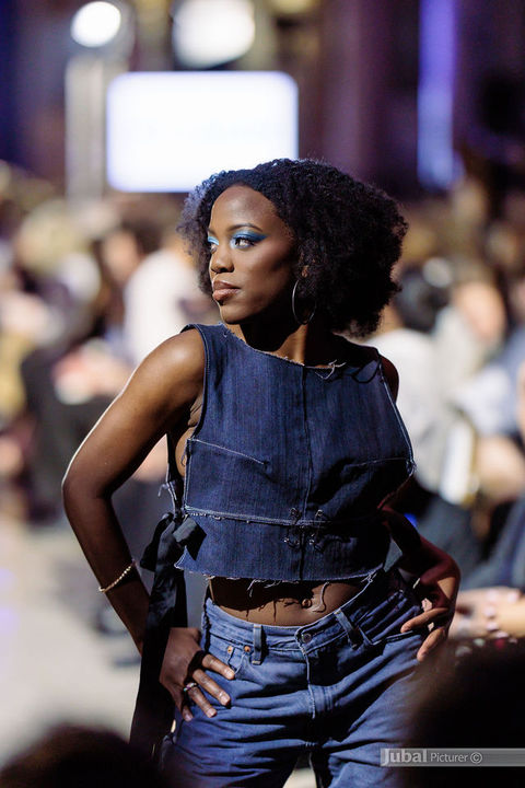 Editorial runway portrait featuring melanin-rich skin, radiant complexion makeup, and modern fashion styling from GAÏA 2026