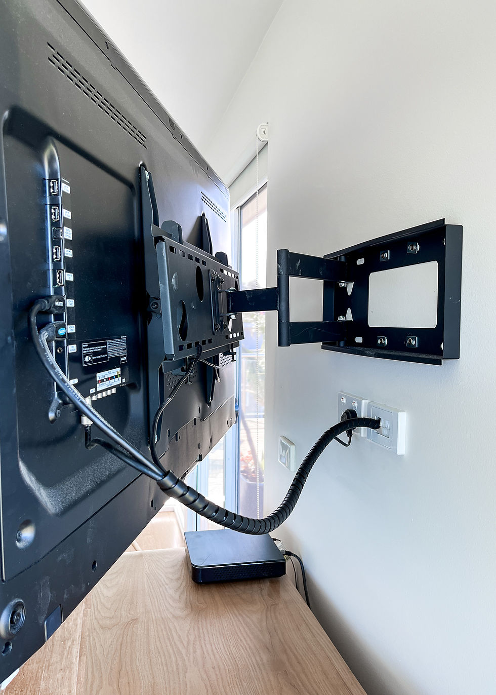 High angle view of a stylish soundbar placed elegantly under a mounted television