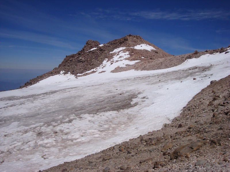 The false summit, with fumaroles dotting its cone.