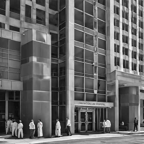 a tall hospital in downtown Los Angeles with patients going inside of it.jpg