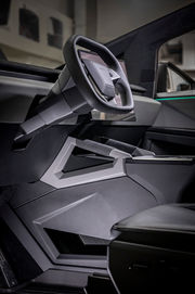 Tesla Cybertruck interior with custom CAD-designed, 3D-printed console and integrated grab handles, wrapped in leather to match the OEM finish by Automotive Design.