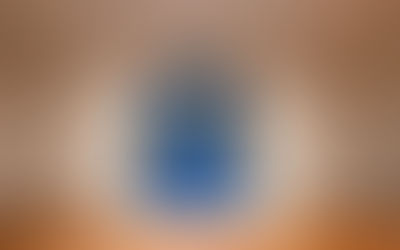Abstract blue-and-gray sculpture on a gallery pedestal, with draped fabric and circular forms, in a minimalist room.