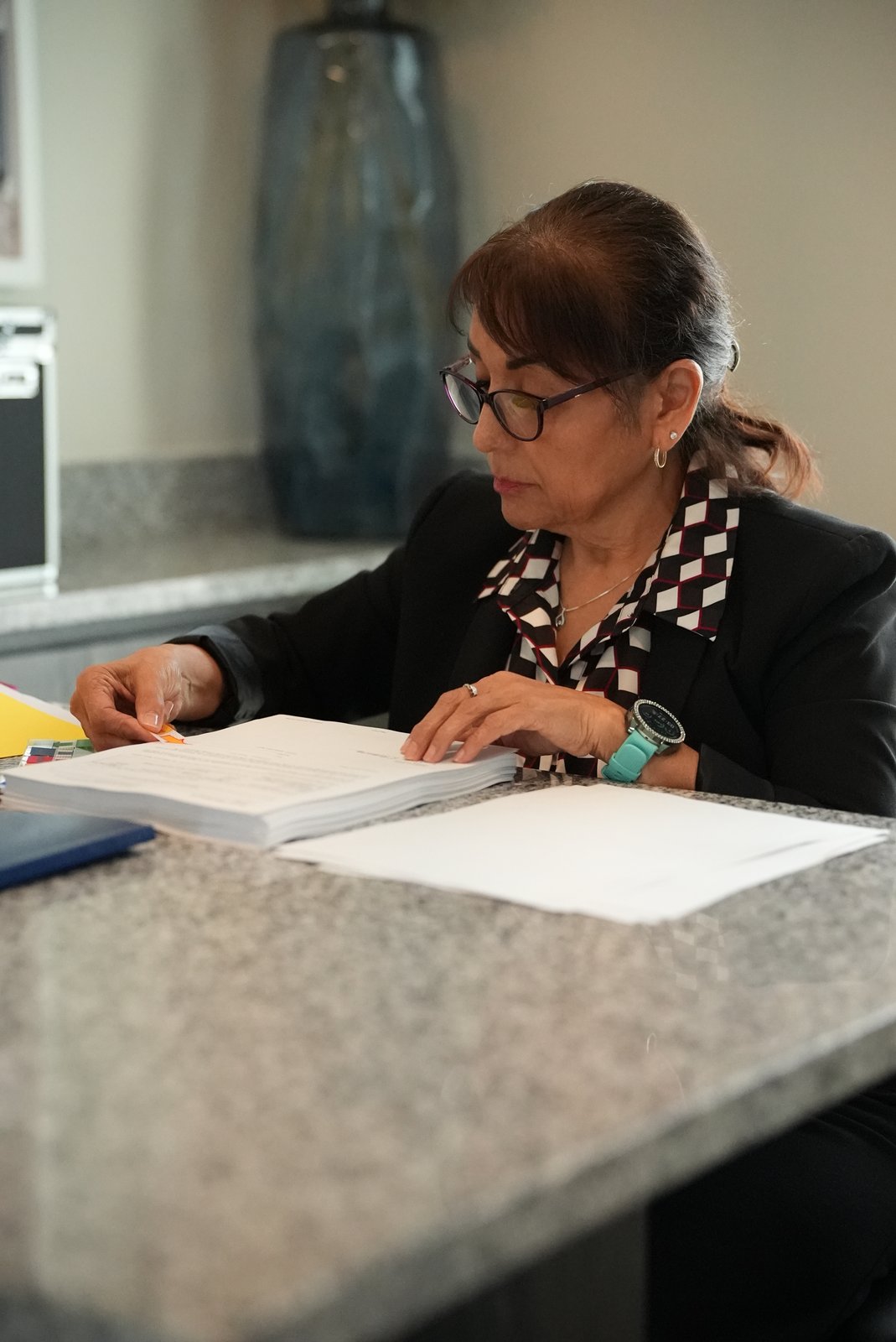 Notary placing signature flags on real estate closing documents