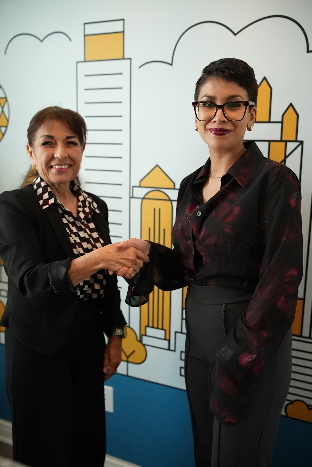 Mobile notary Andrea Garza shaking hands with a client after a real estate closing in Terrell, TX