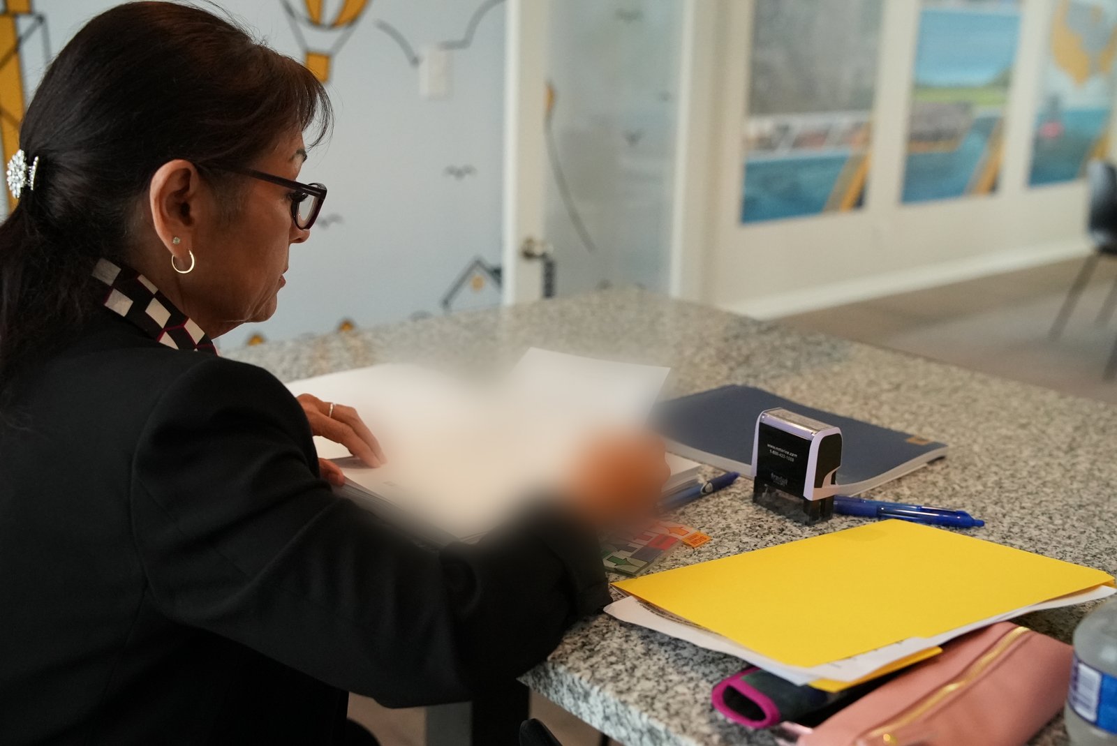Mobile notary verifying a loan document package before a closing
