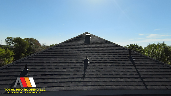 Finished roof installation by Total Pro Roofing on a two-story suburban home.
