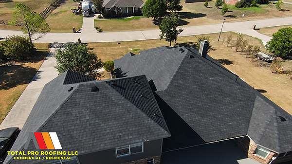 Finished roof installation by Total Pro Roofing on a two-story suburban home.