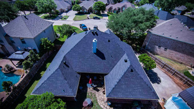 Aerial photo of a home with a newly installed asphalt shingle roof completed by High Bar Roofing & Construction in Haslet, Texas.