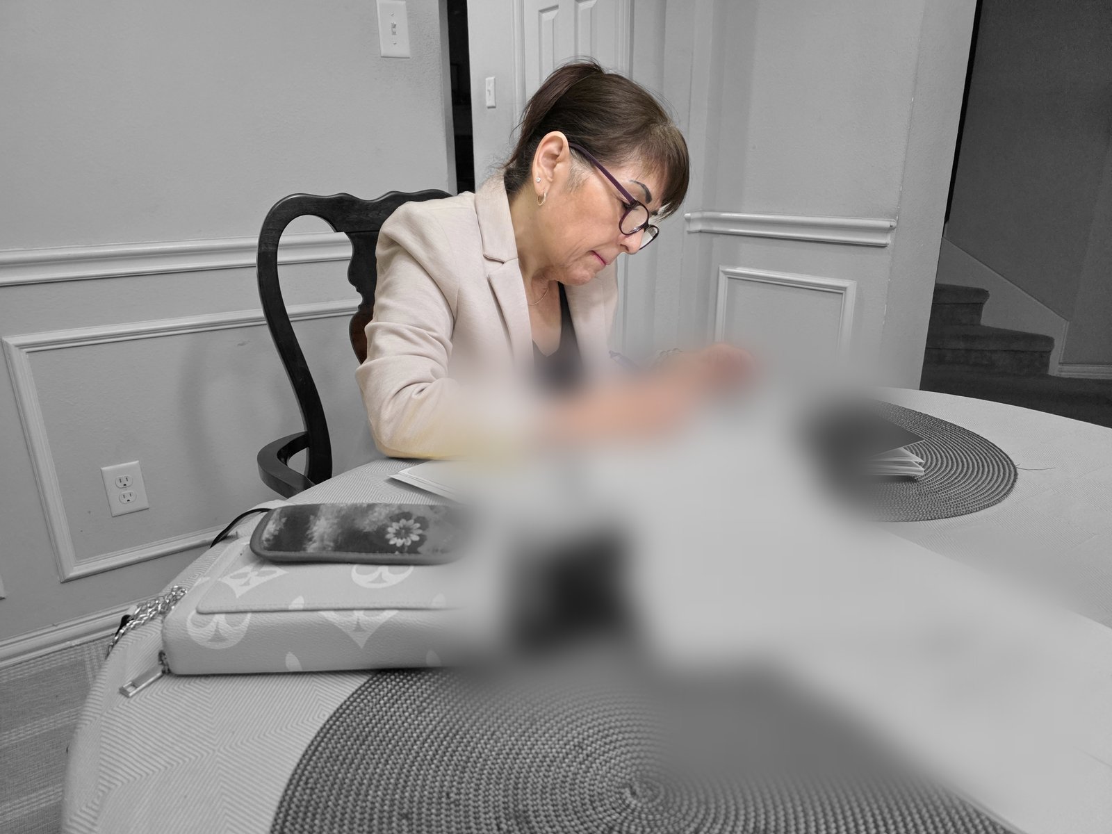 Mobile notary signing agent working at a client's dining table in the DFW metro