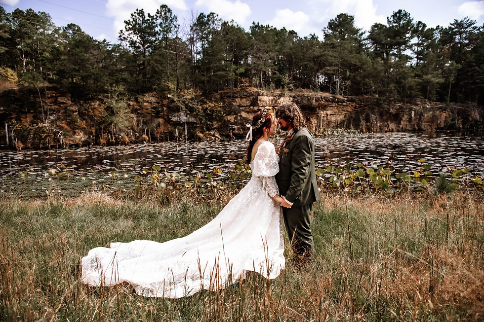 Bride and groom sharing intimate moment before outdoor forest wedding ceremony on Alabama farm.