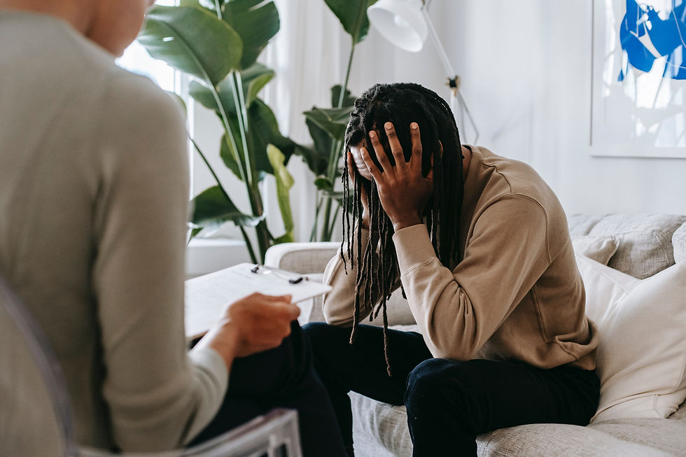 man in therapy head in hands
