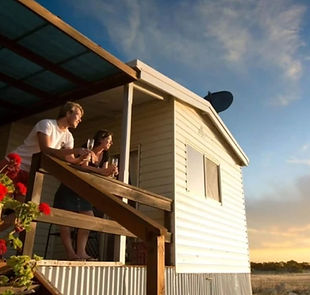 Couple enjoys sunset drinks on deck