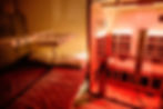 Close-up view of an infrared heat lamp glowing softly in a wellness room