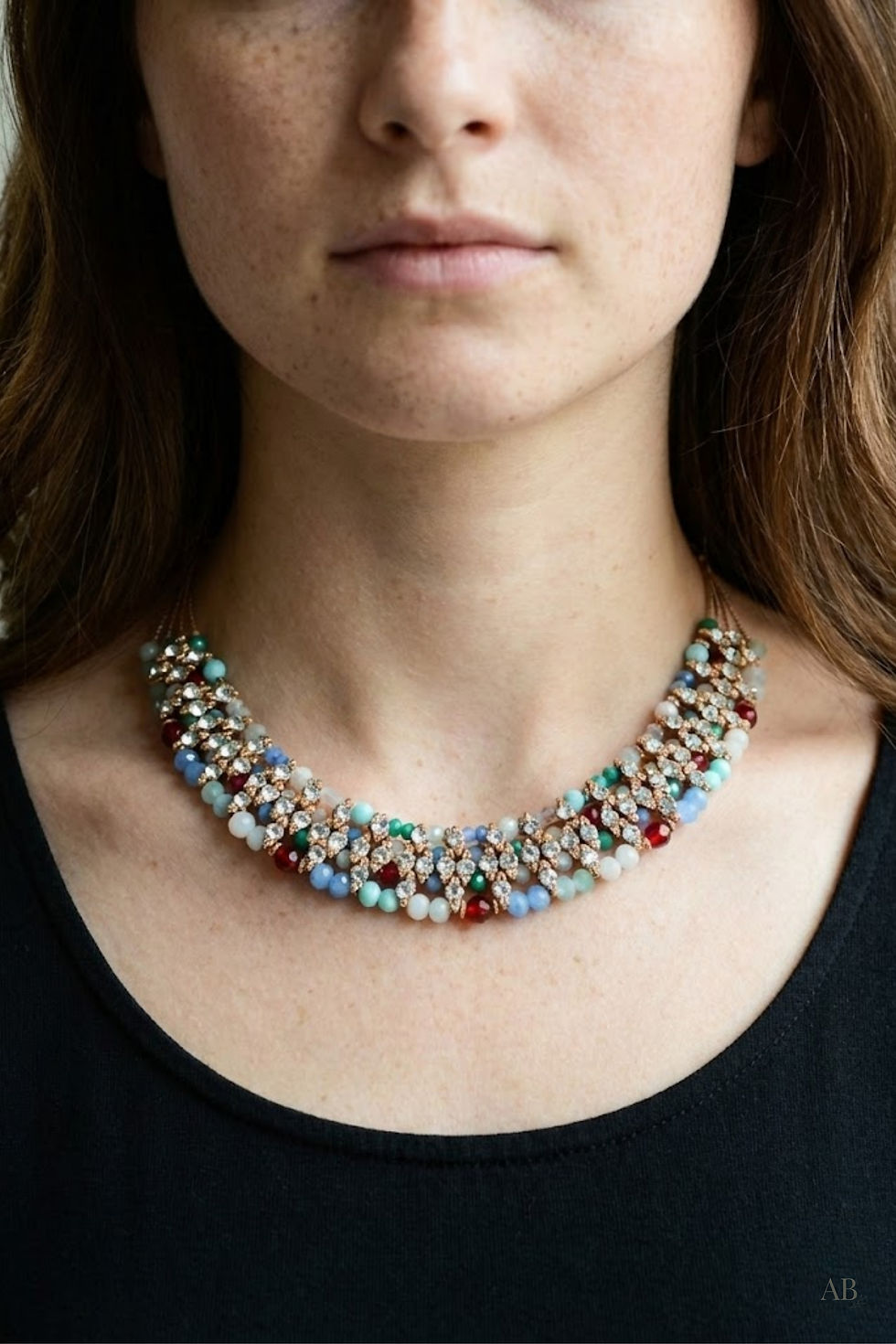 Multi-stone wire statement collar necklace worn at neckline, bold beaded statement jewelry with colorful stones.