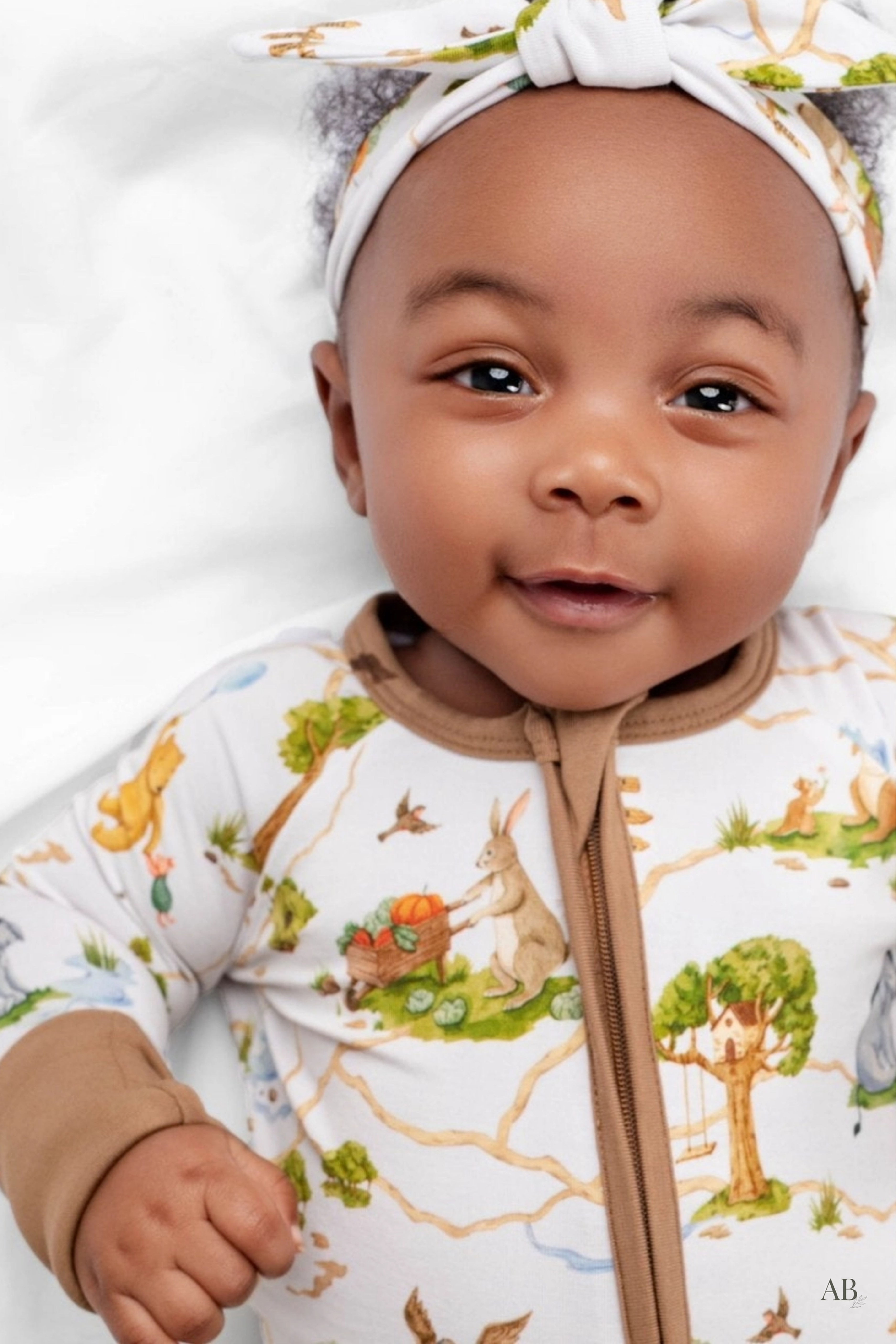 Close-up of baby in the Winnie the Pooh bamboo sleeper showing the two-way zipper.