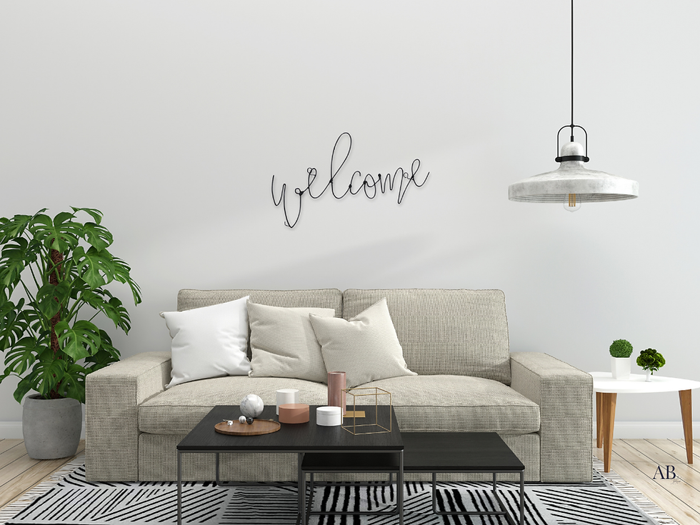 Black wire 'Welcome' wall sign above beige sofa, modern rustic living room décor with greenery and pendant light.