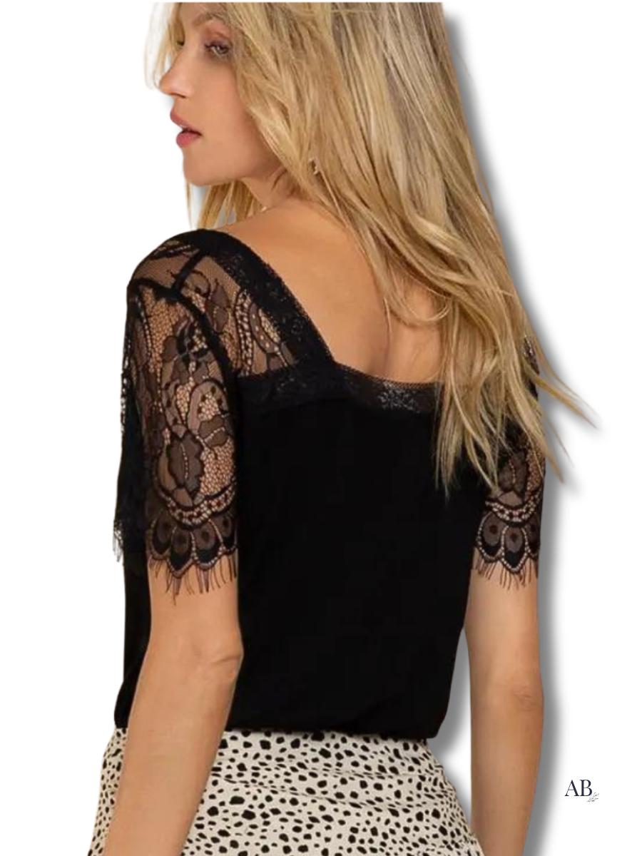 Back of black lace v-neck top featuring sheer lace sleeve and upper panel