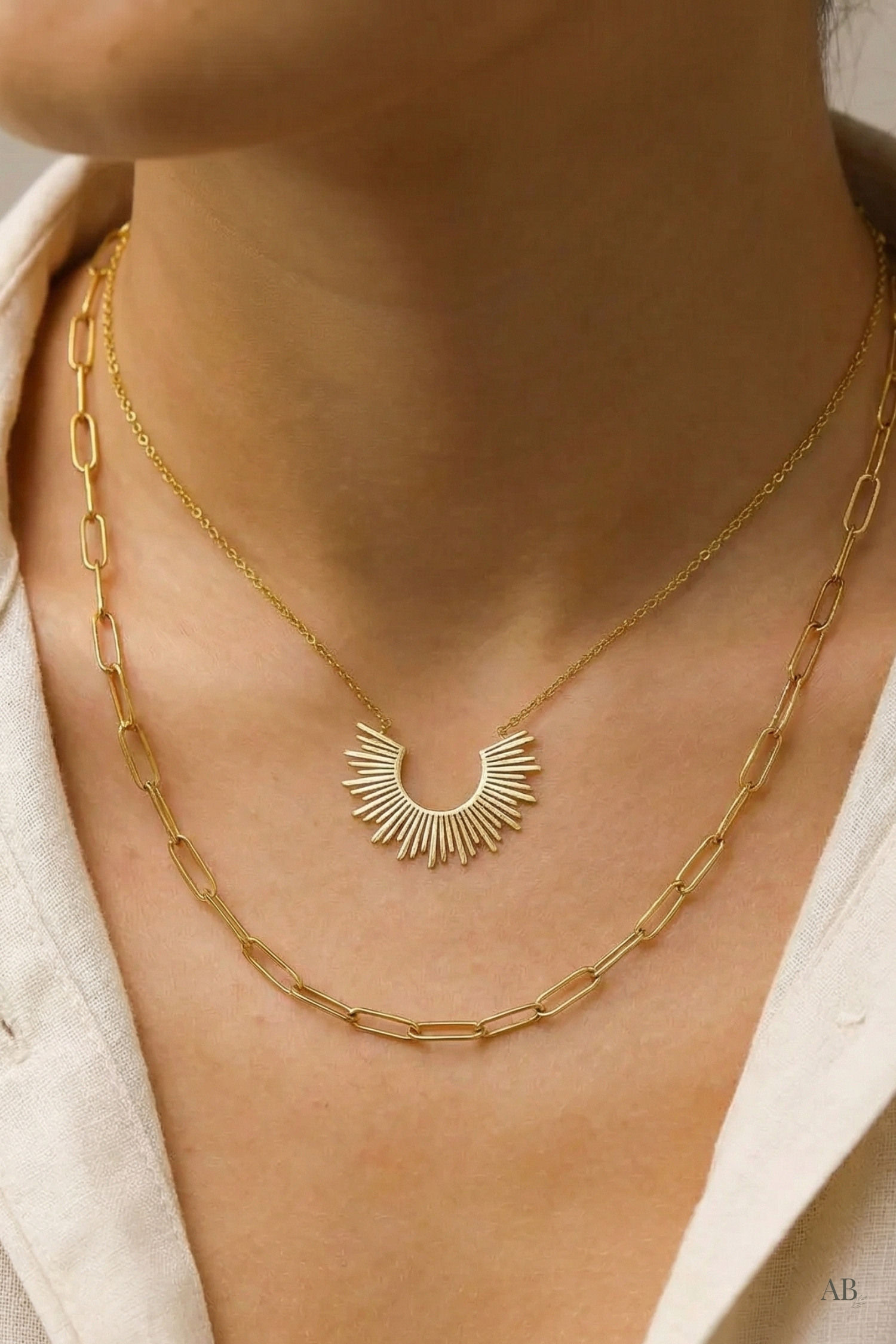 Model wearing a waterproof 18k gold layered sunburst paperclip chain necklace from a Michigan boutique.