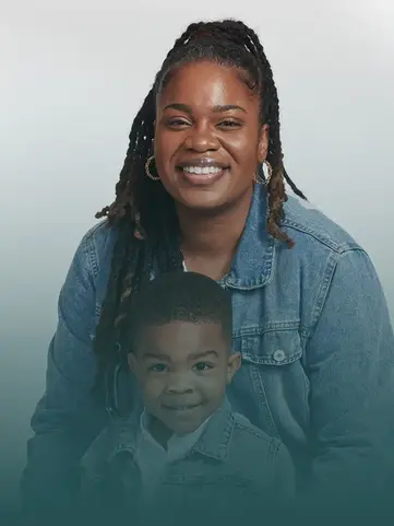 Smiling Black woman with dreadlocks and young boy posing together.