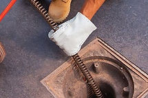 Tip Top Technician cleaning drain with machine in Phoenix